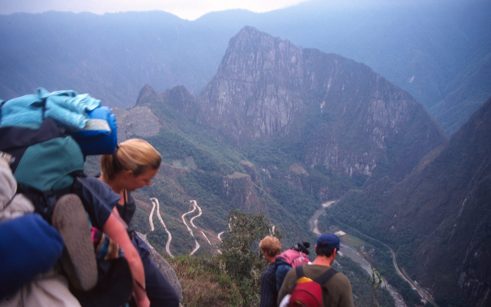 Hikers on the stone-paved Inca Trail high above the Urubamba valley