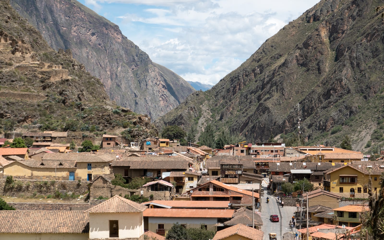 A narrow cobbled Inca street with original stone walls in Ollantaytambo