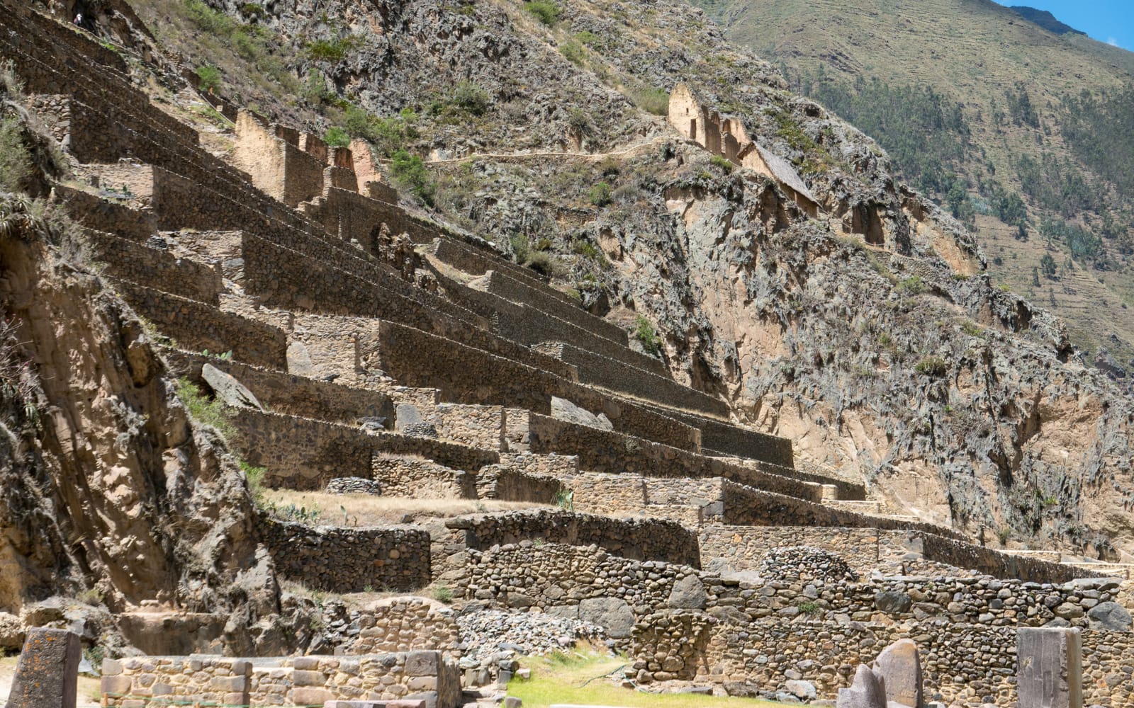 Visitors climbing the terraces of the Ollantaytambo archaeological site